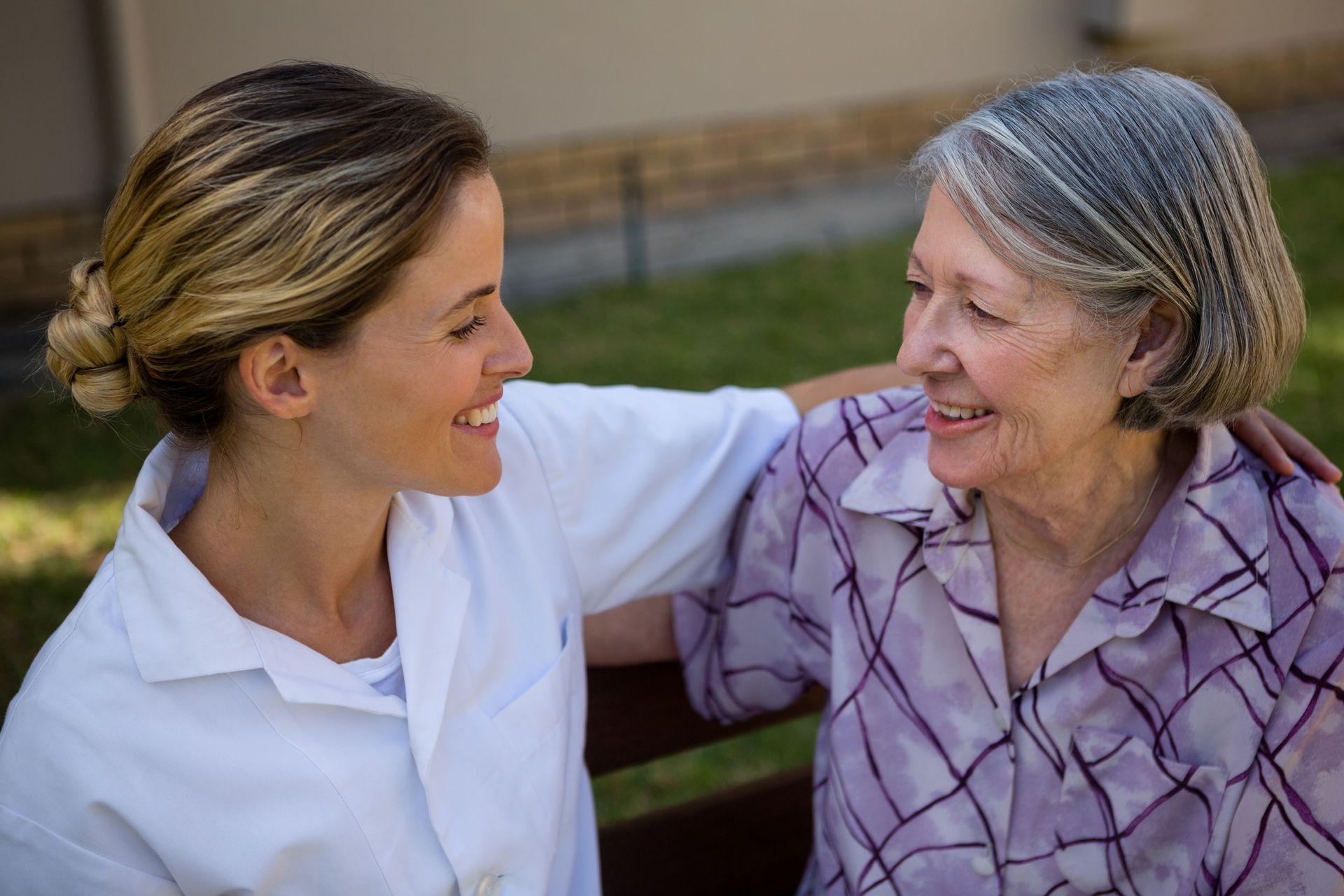 Two women having a friendly discussion on a bench