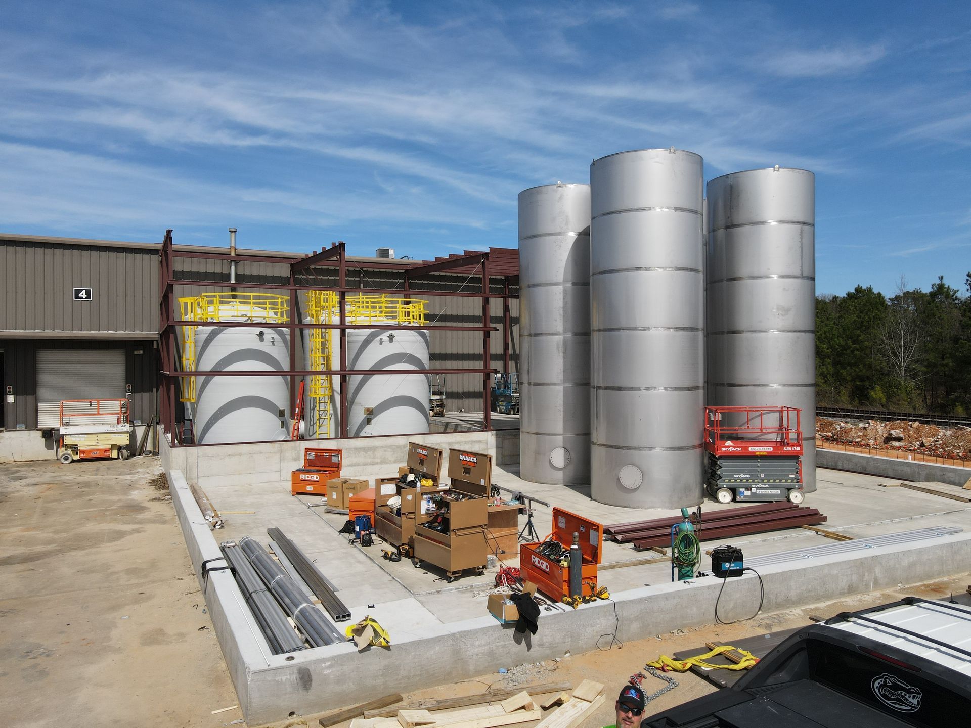 A truck is parked in front of a building under construction.