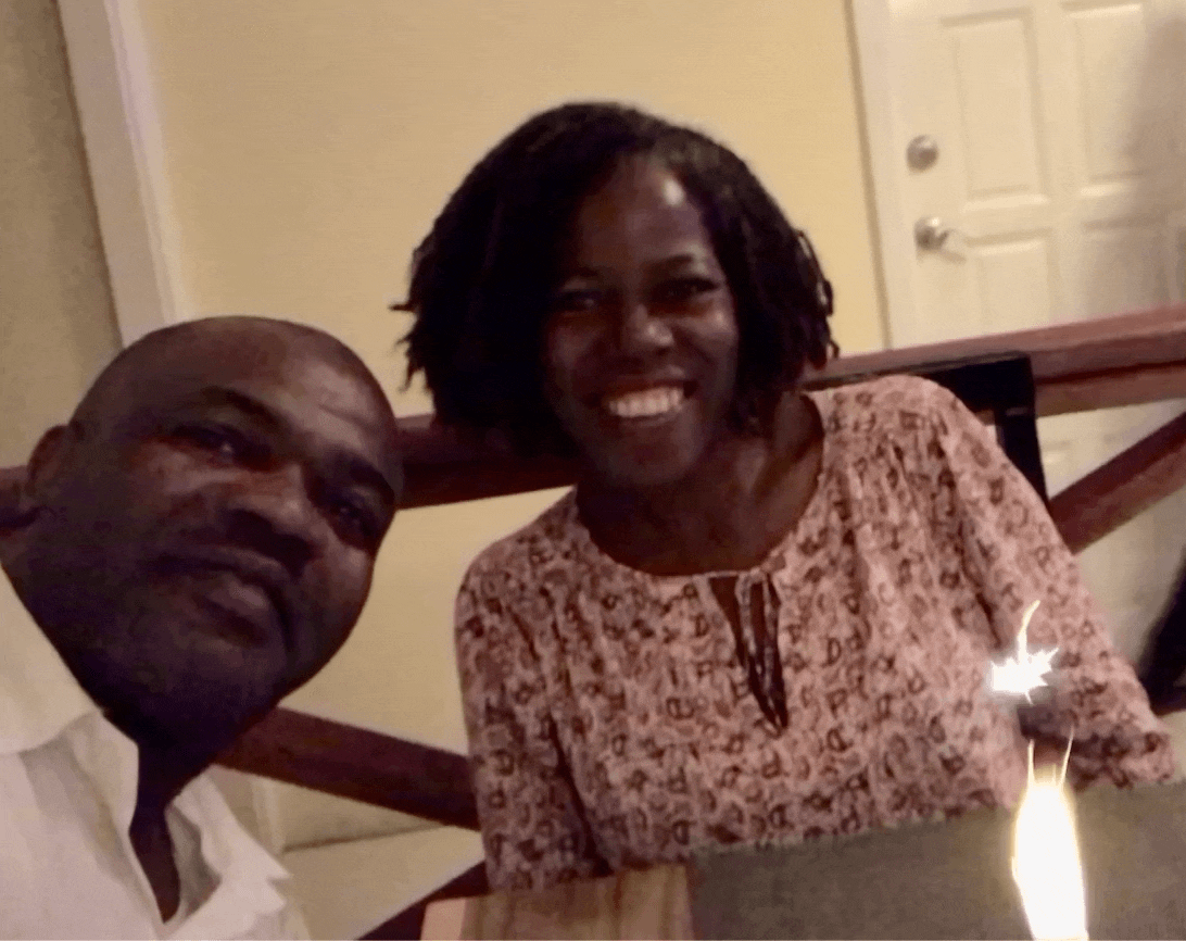 A man and a woman sitting at a table with a candle