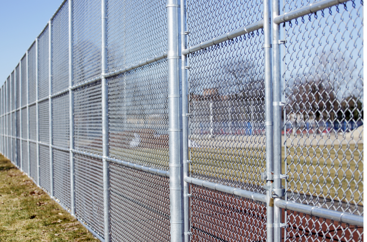 a chain link fence surrounds a baseball field