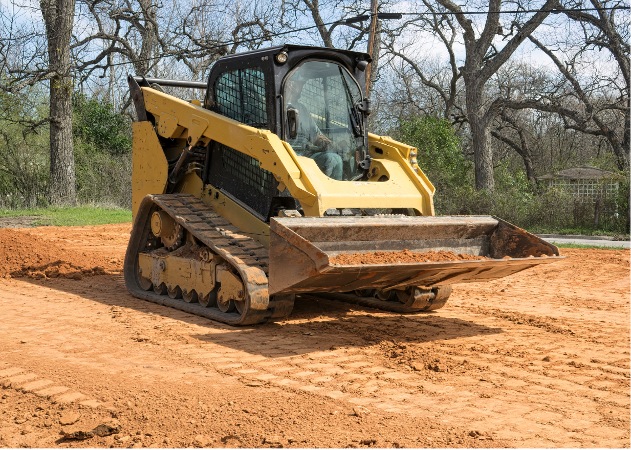 a yellow bulldozer with a bucket that has the letter t on it