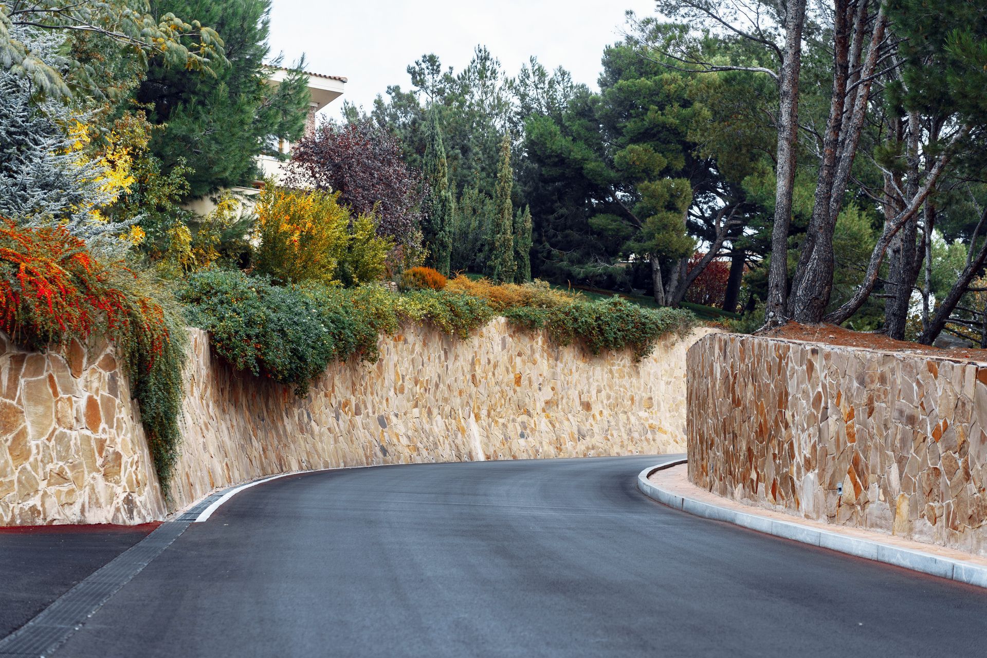 a large stone retention wall is being built on the side of a road