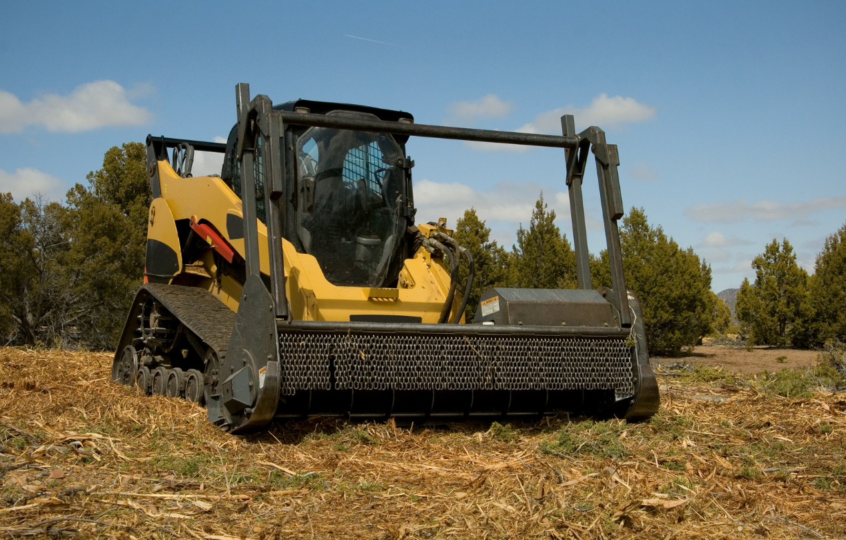 a yellow and black tractor with the word cat on it