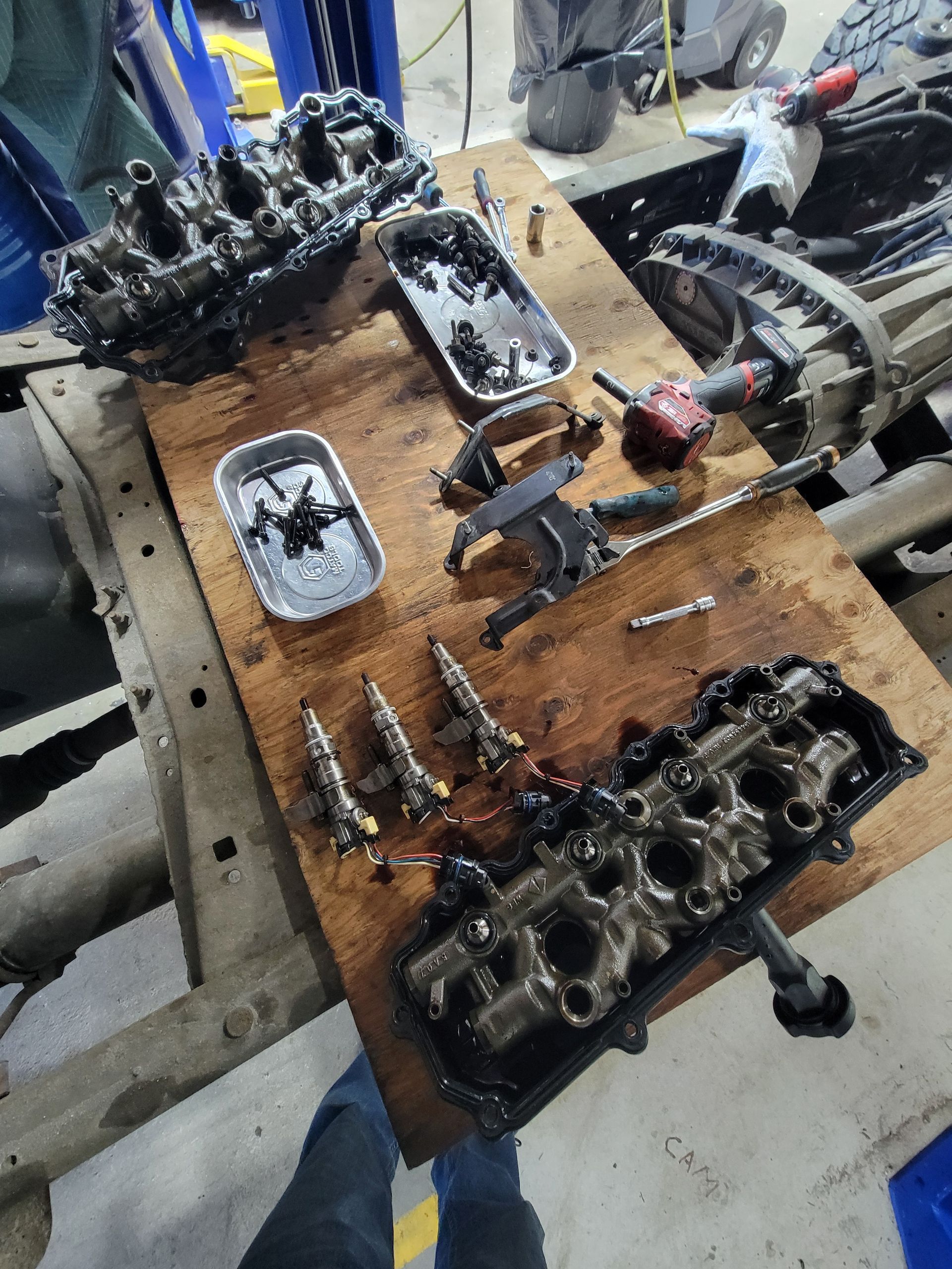 Engine parts on a wooden board in a garage | Countryside Automotive