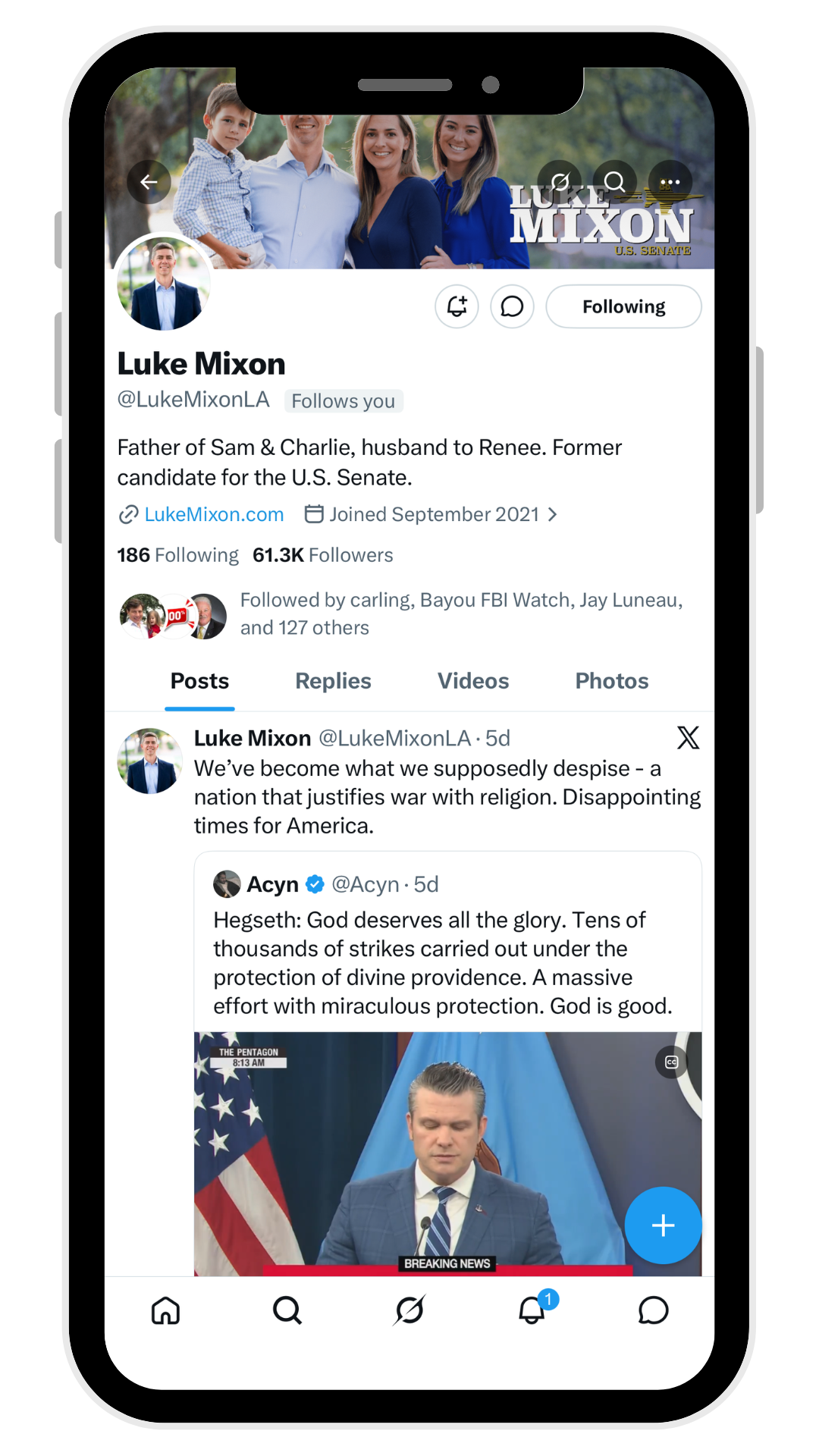 Phone screen showing Twitter profile and a tweet with a man speaking at a podium against a U.S. flag backdrop