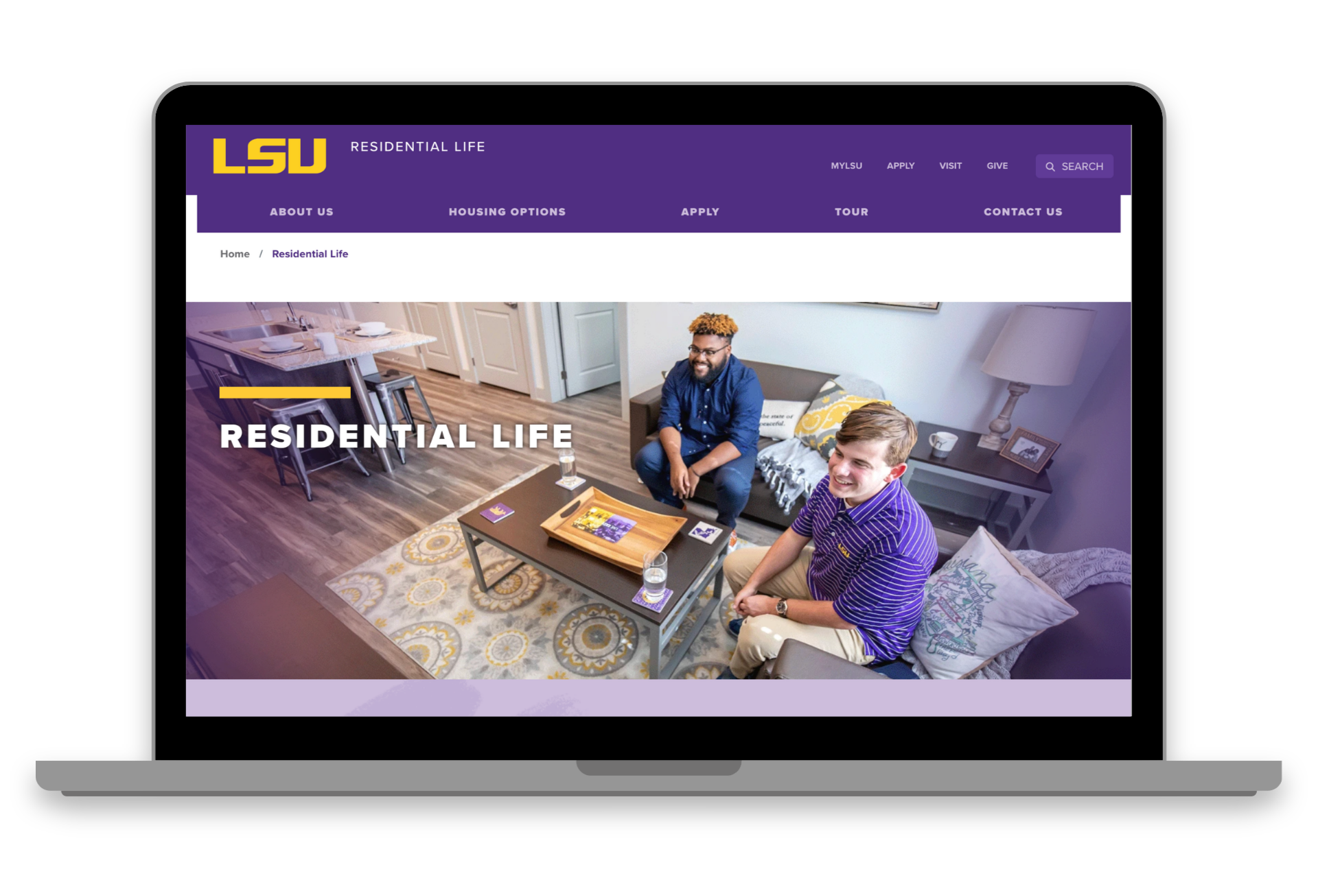 LSU Residential Life webpage on a laptop, showing a purple header and two people on a couch in a dorm room