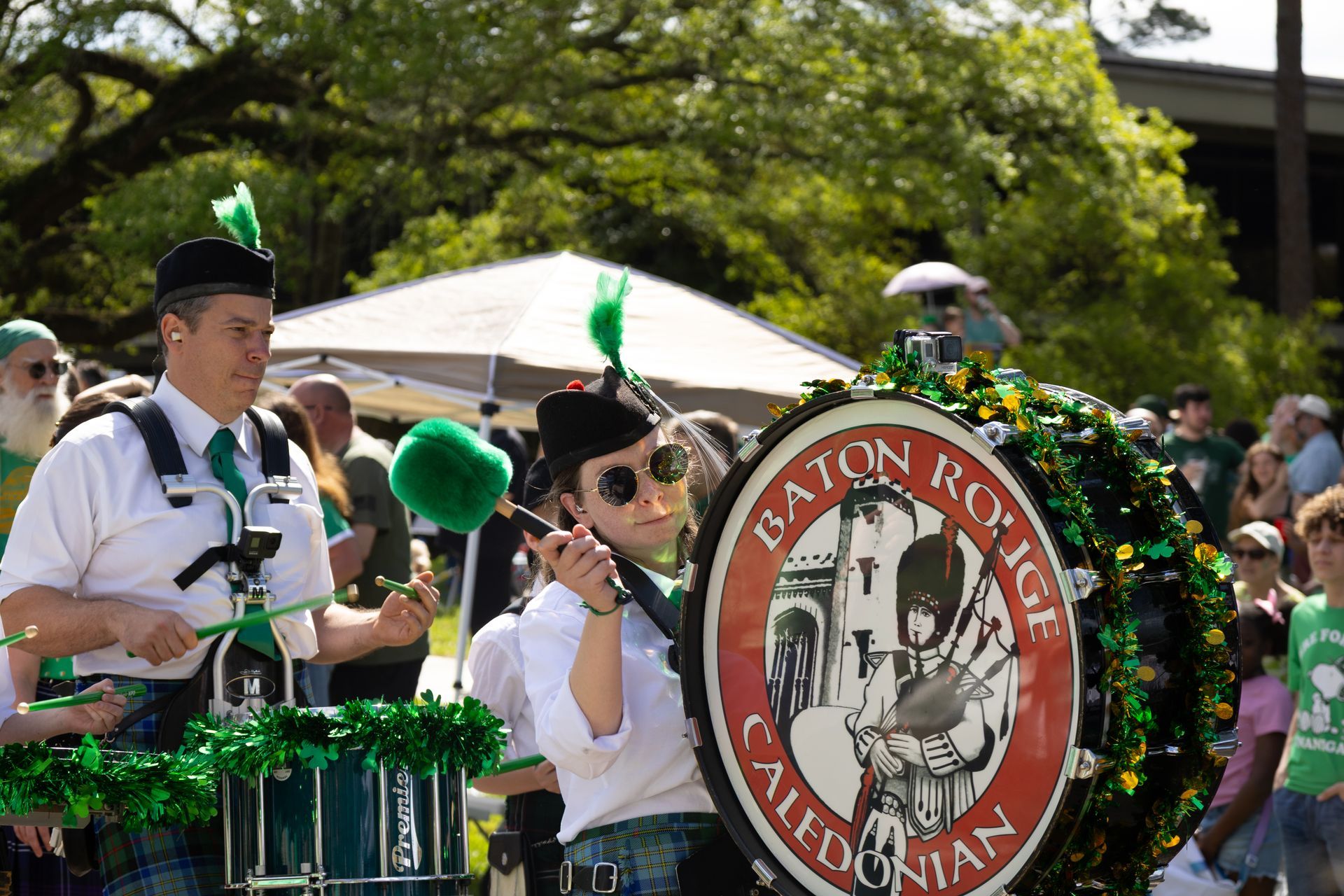 Parade drummer and bass drum with “Eaton Road California” emblem, outdoors in daylight