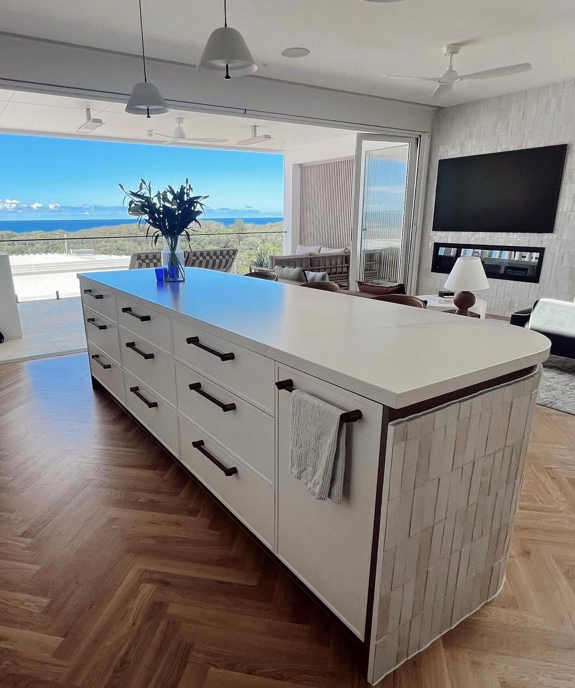 Kitchen island with white cabinets, black handles, light counter — Tile Trends in Tweed Heads South, NSW