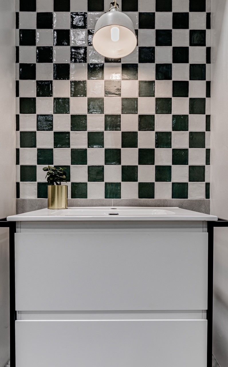 Bathroom With A Sink And A Checkered Wall — Tile Trends in Tweed Heads South, NSW
