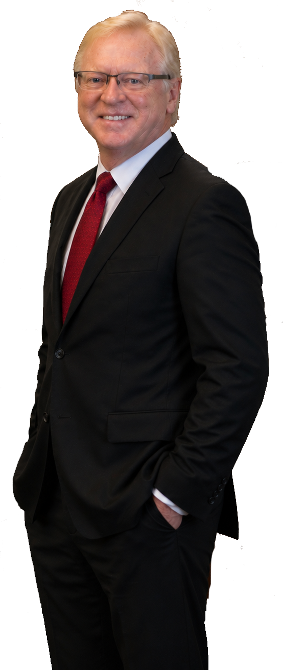 Smiling man in a black suit with a red tie, standing against a white background