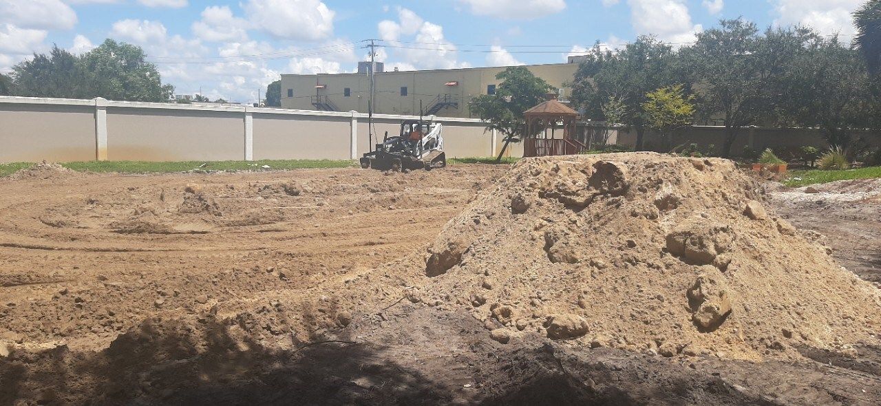 A pile of dirt is sitting in the middle of a dirt field.