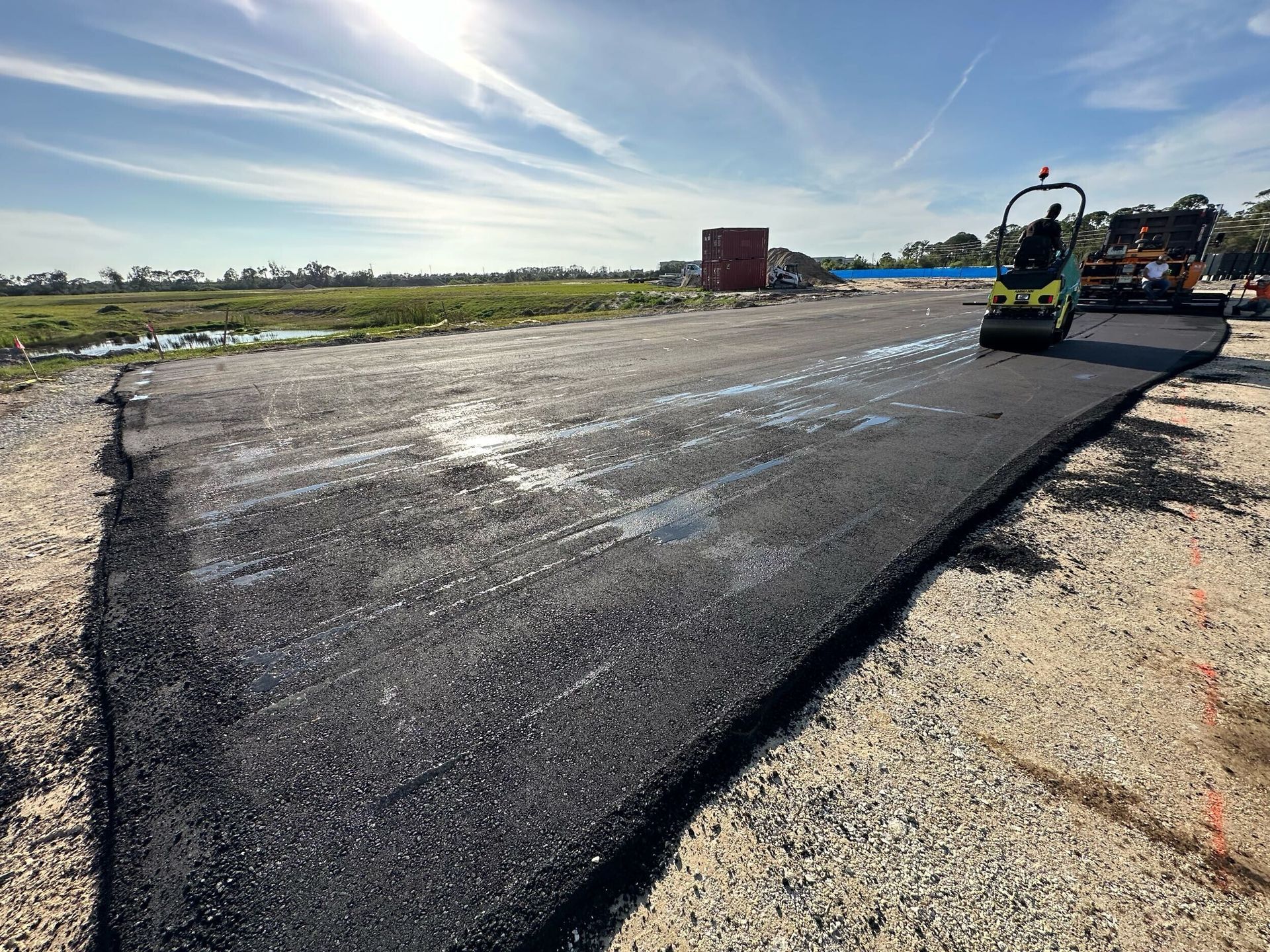 A roller is rolling asphalt on a road.