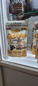Bag of Raw Bakery chocolate protein brownies, in a store display.