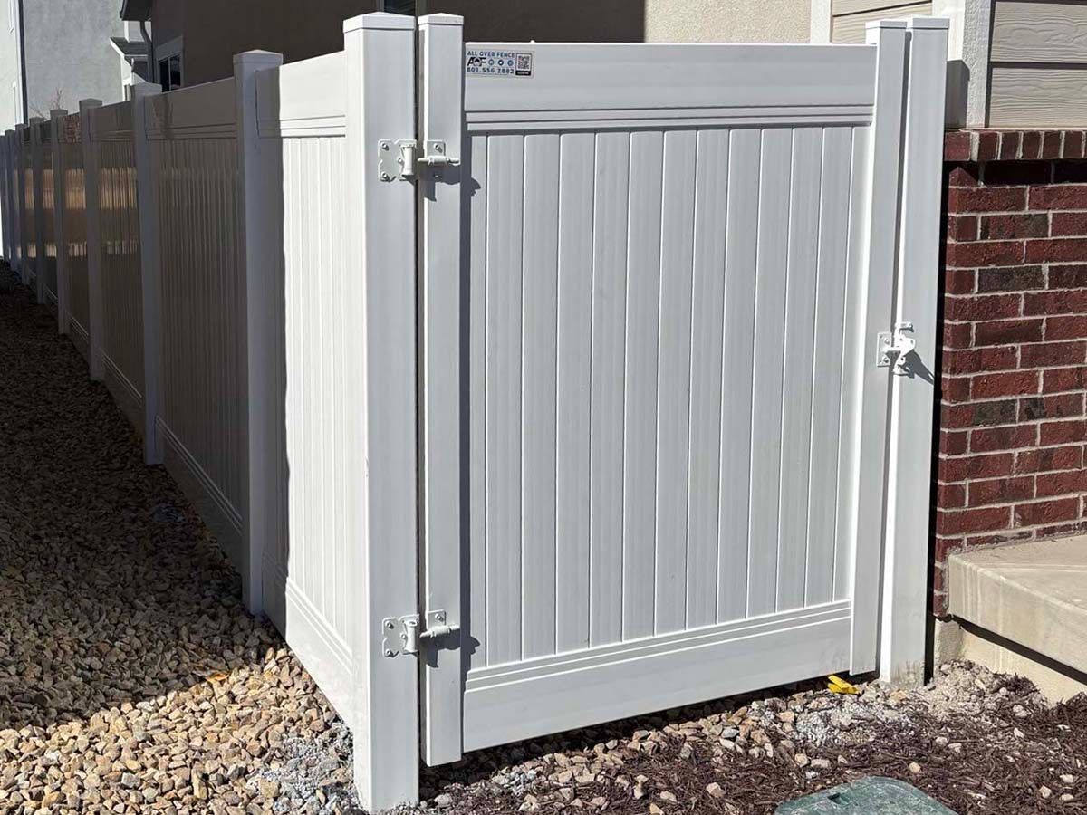 White vinyl privacy fence gate shown open and closed, with black hinges and latch.