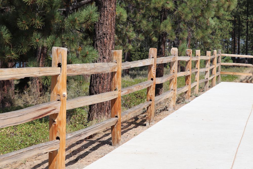Wooden three-rail fence with posts on a white background