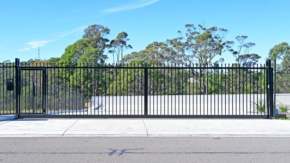 Black metal swing gate with vertical bars, shown closed and open on a white background