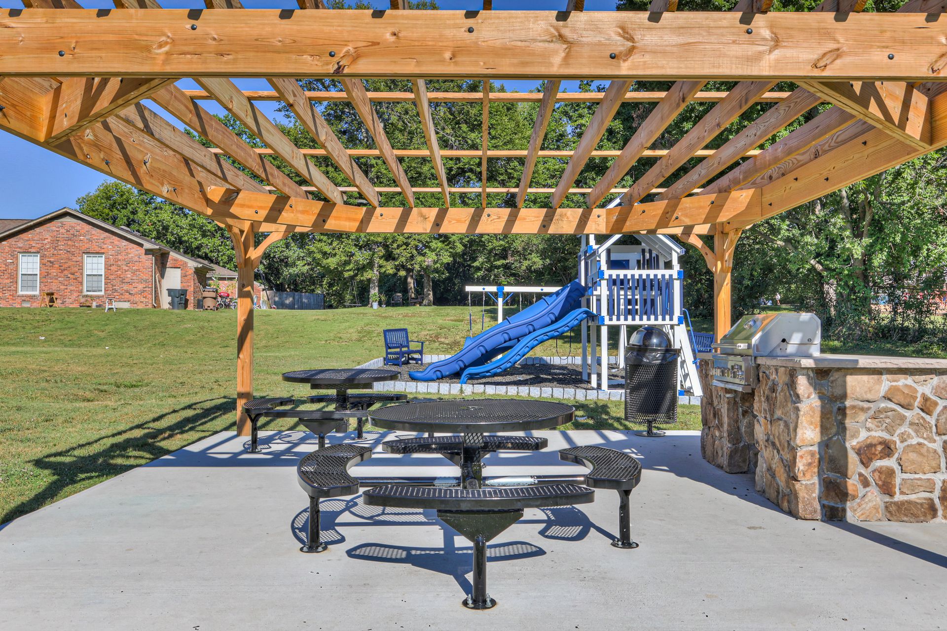 Photo of a community grill area, showing the barbecue grill and the seating
