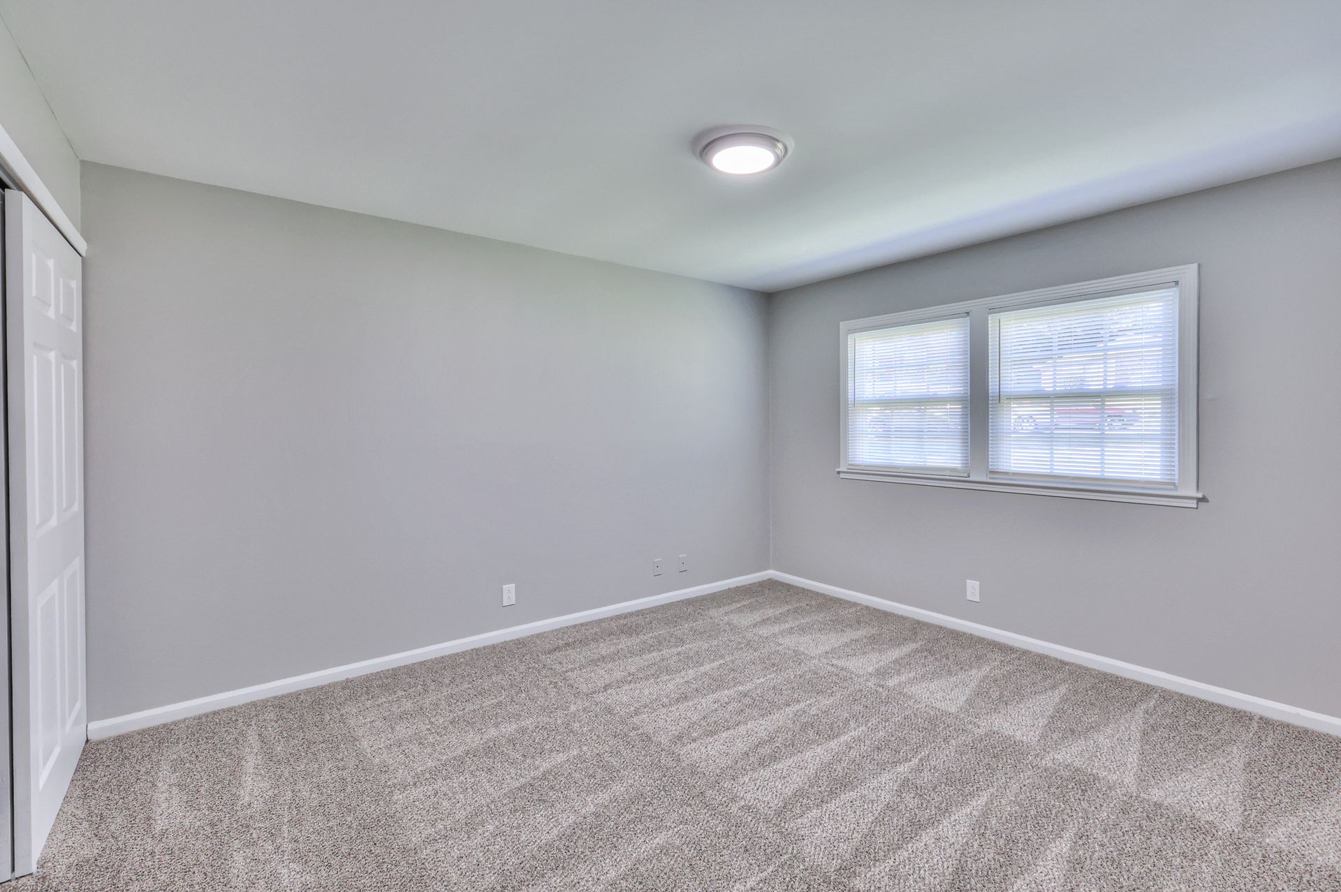 Photo of a carpeted bedroom seen from a different angle