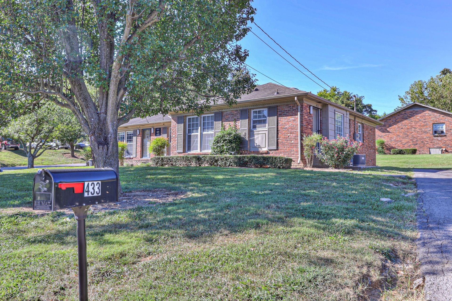 Photo of a single home, surrounded by large lawn space