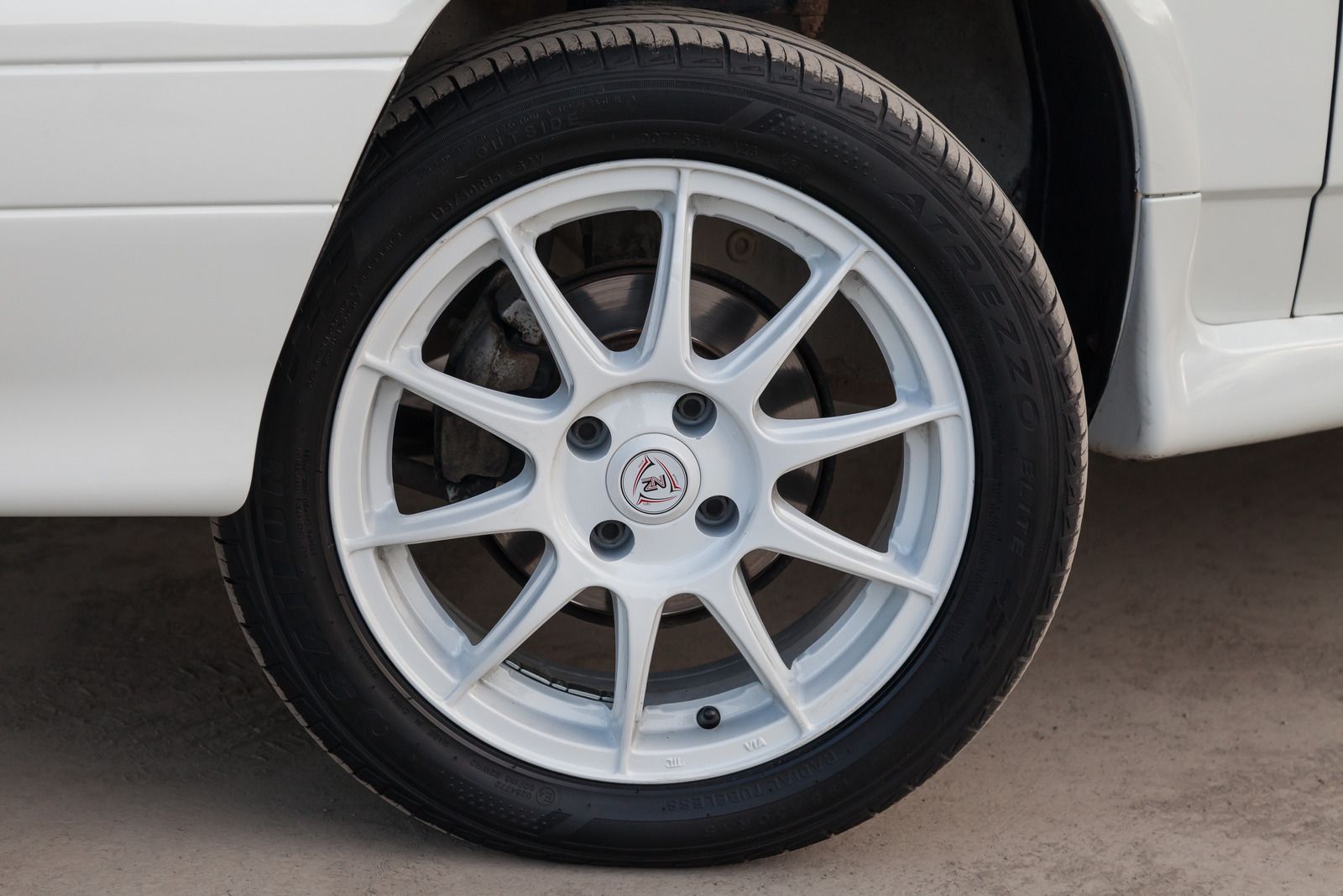 White car wheel with black tire.