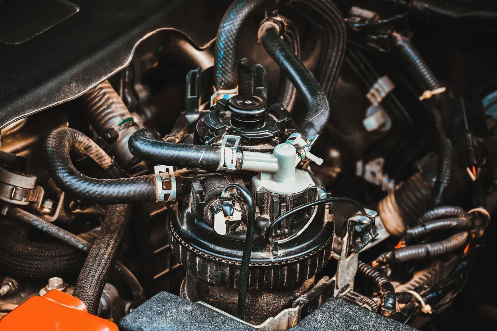 Engine components with black hoses and connections.