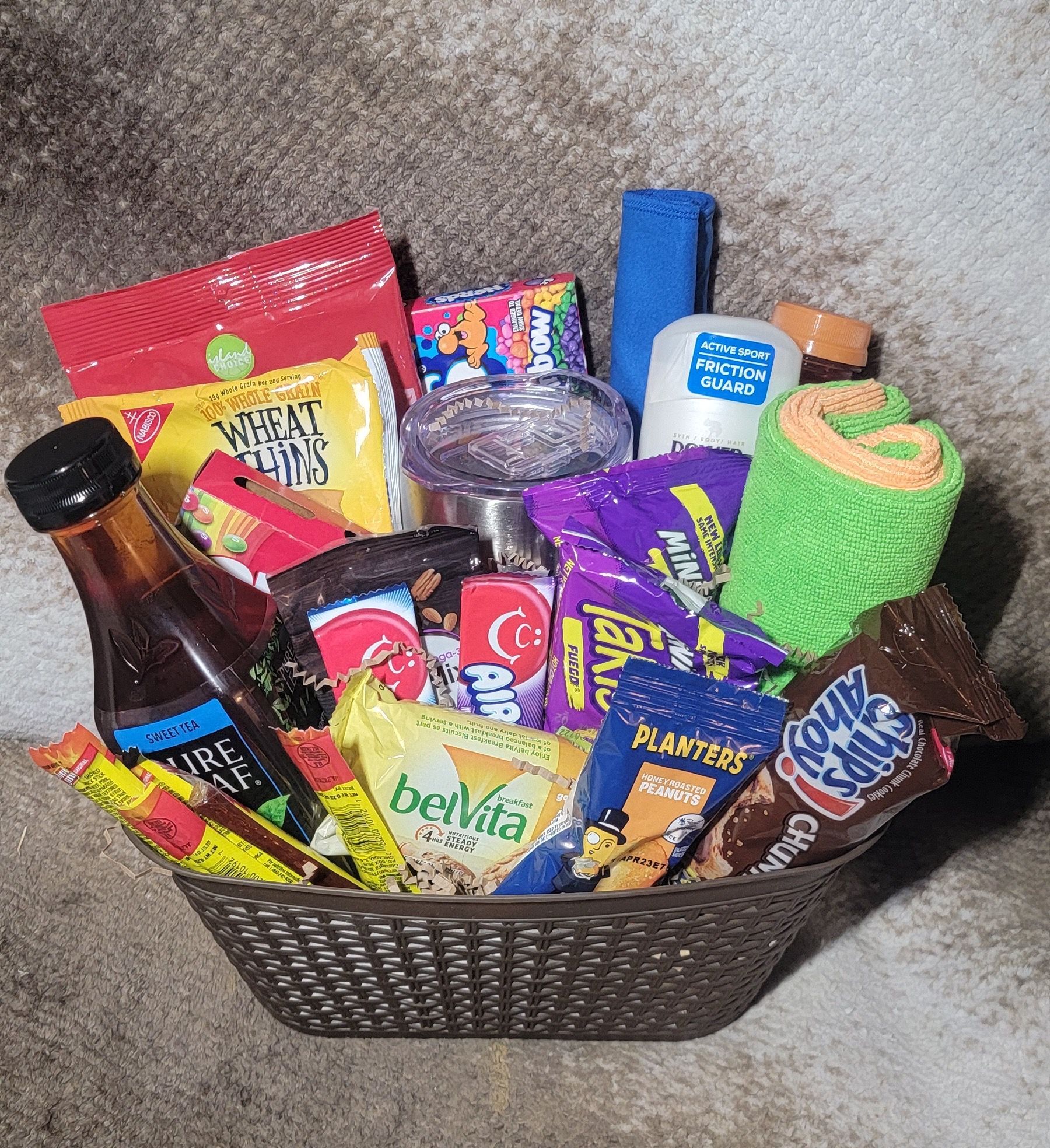 Gift basket of assorted snacks and treats in a black woven container