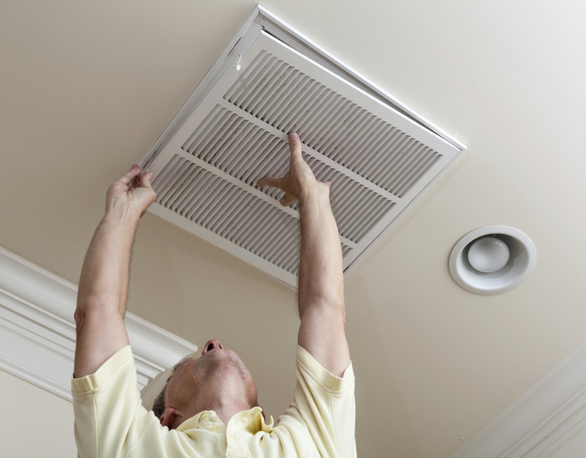 Repairman Inspecting HVAC Unit | Stephenville, TX | Alderfer's Air Conditioning & Refrigeration Service Inc