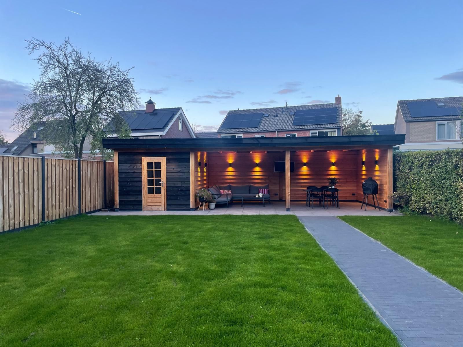Stijlvolle en duurzame tuinberging met overkapping, perfect voor extra opslag en een gezellige loungeplek. Geniet het hele jaar door van comfort en een moderne uitstraling in uw tuin. Ideaal als tuinhuis op maat voor elke buitenruimte. 