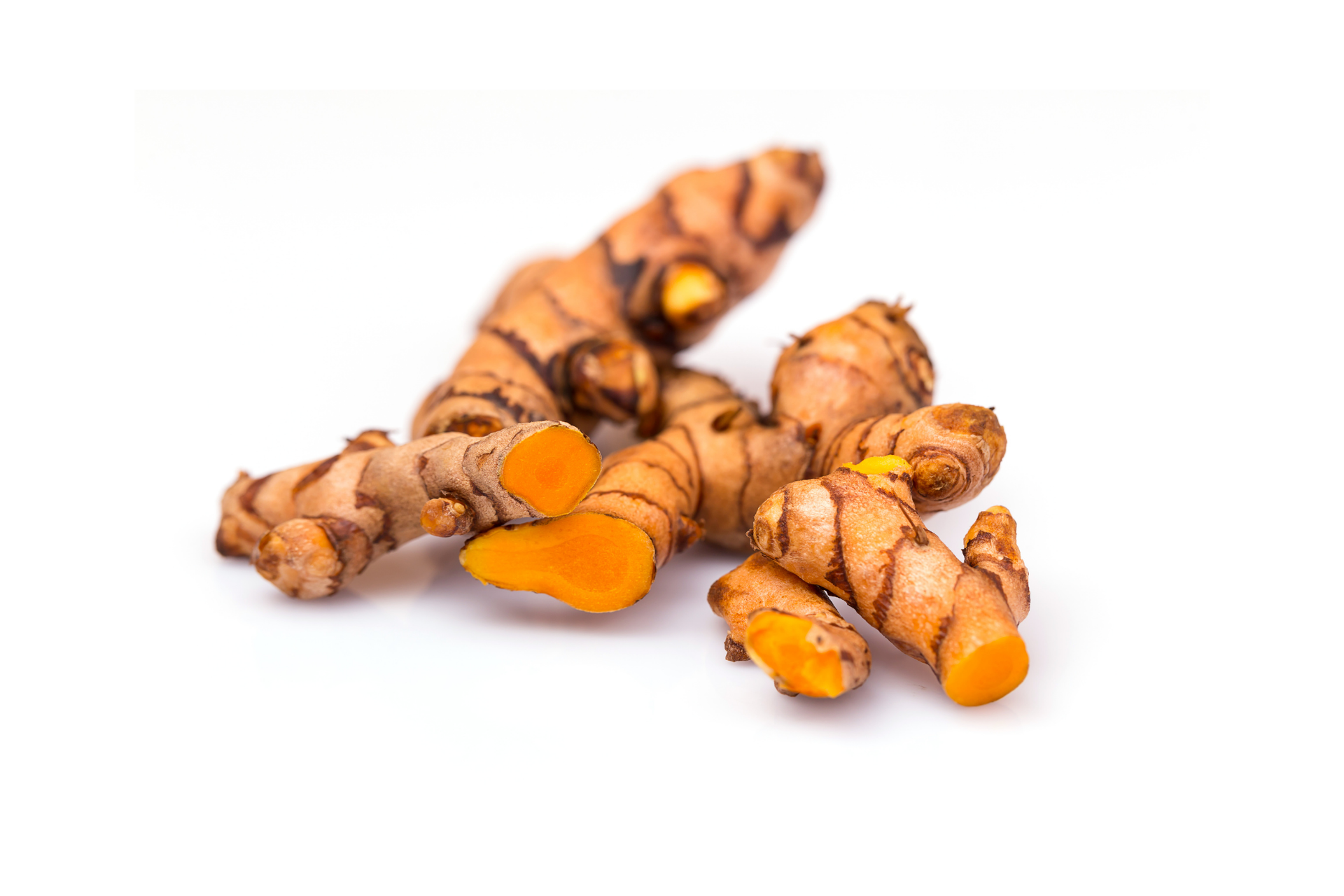 Fresh turmeric roots with orange interior and natural skin