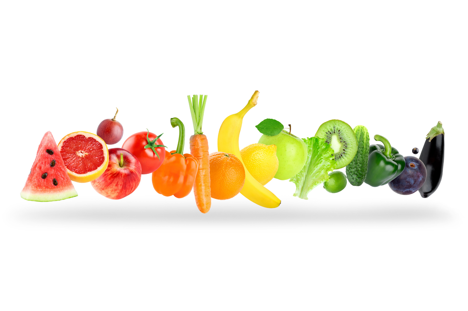 Colorful assortment of sliced fruits arranged in a rainbow on a white background