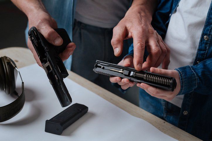 man pointing at the handgun spring