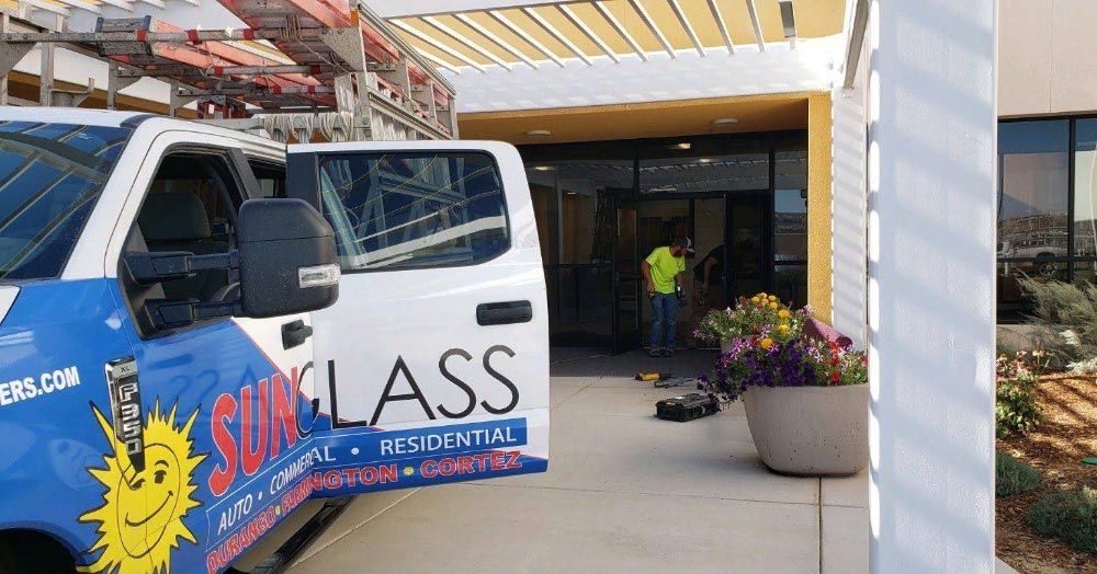 a sunglass truck is parked in front of a building