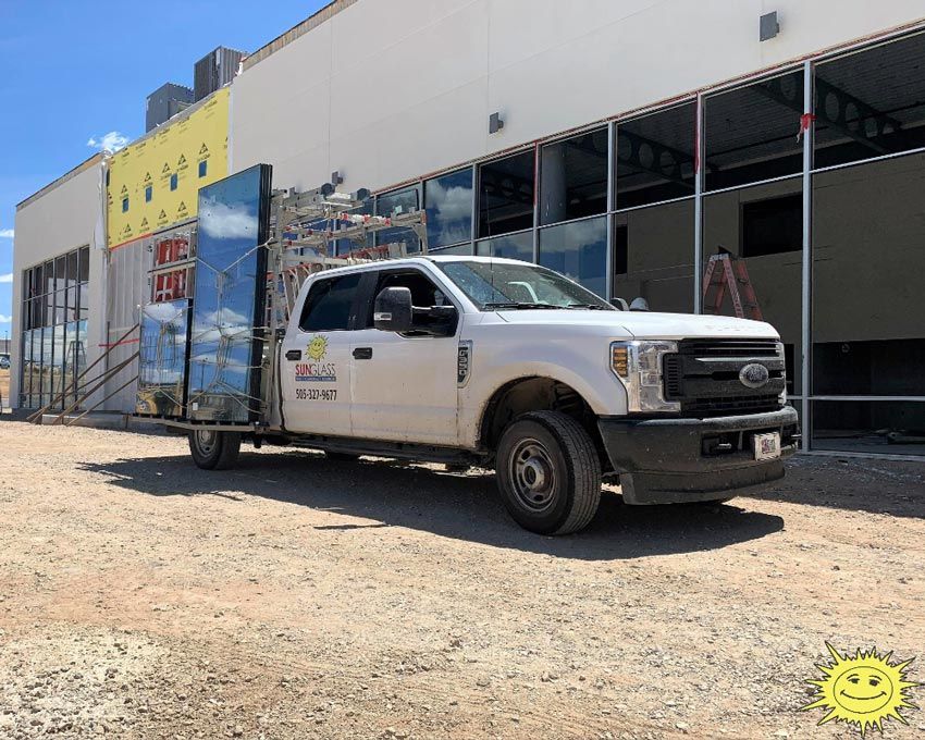 a white truck is parked in front of a building under construction .