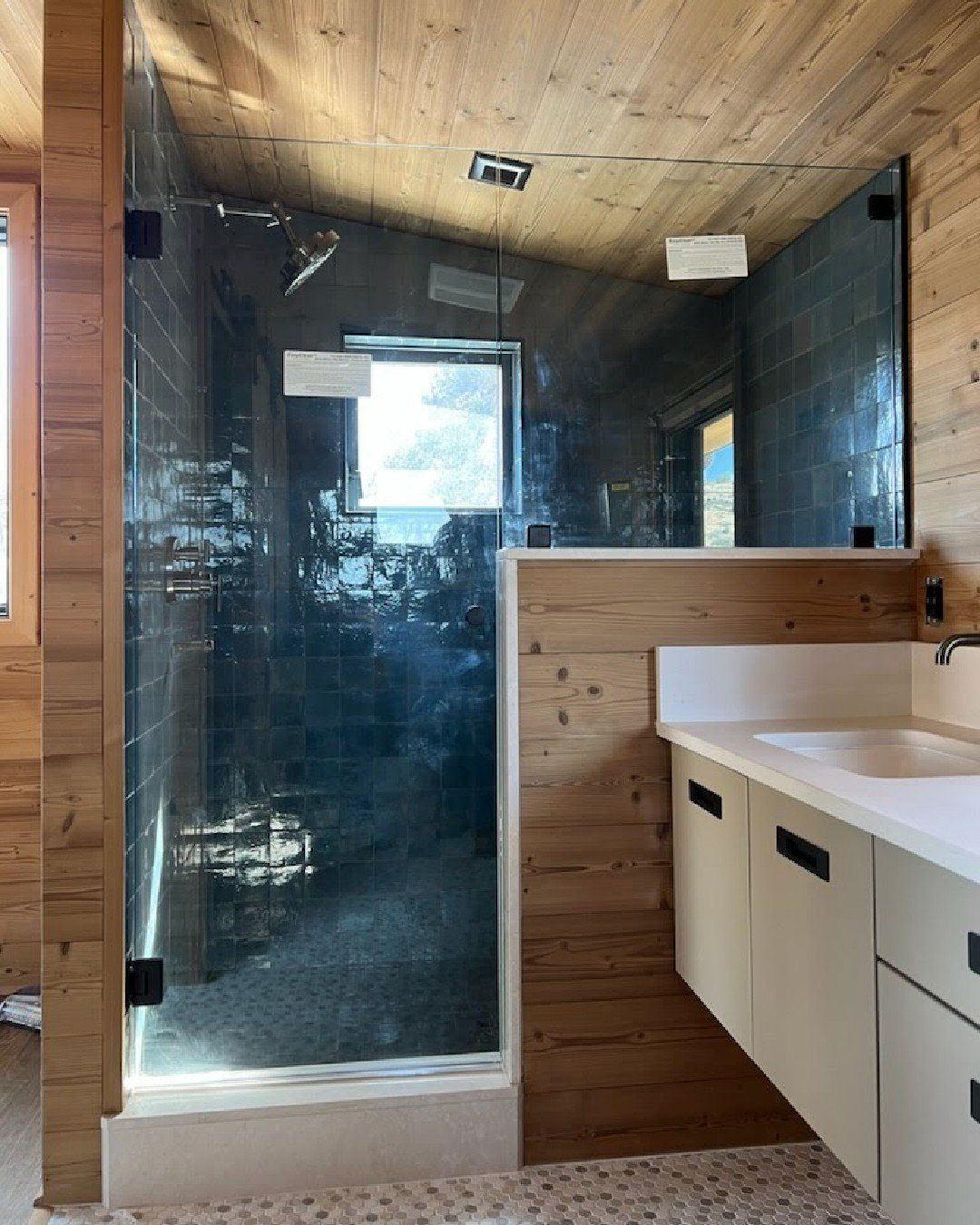 bathroom with a walk in shower, and a custom shower glass installed by Sun Glass