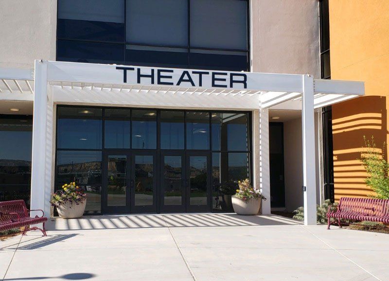 front of a theater with tall windows and glass doors installed Sun Glass
