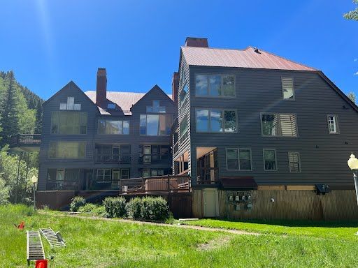 A large house with alot of windows by Sun Glass