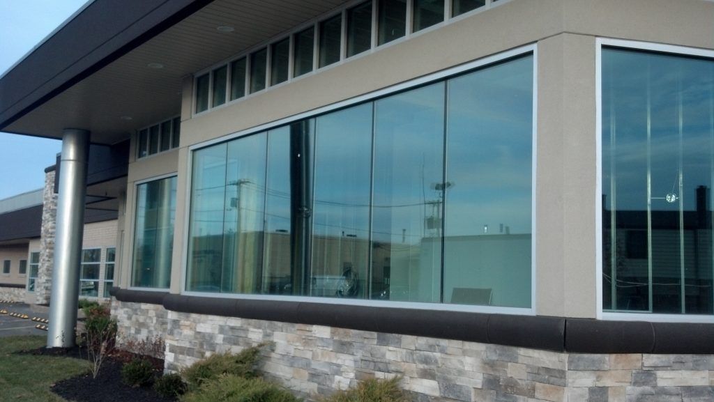 Huge glass windows on the side of building by Sun Glass
