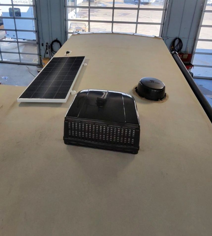 A table with a solar panel and a fan on it