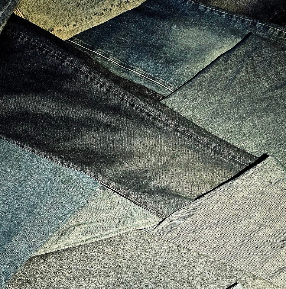 A close-up view of dark blue fabric with a subtle, textured weave and a soft diagonal fold.