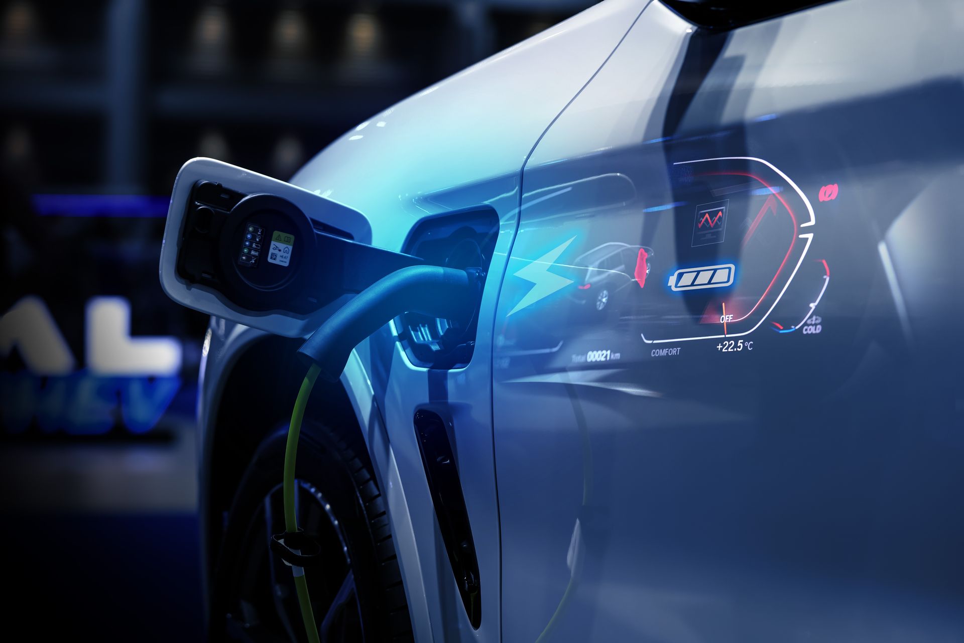 A close up of an electric car being charged at a charging station.