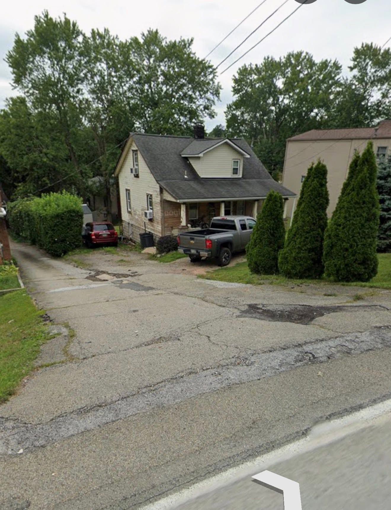 A group of men are laying asphalt on a road.