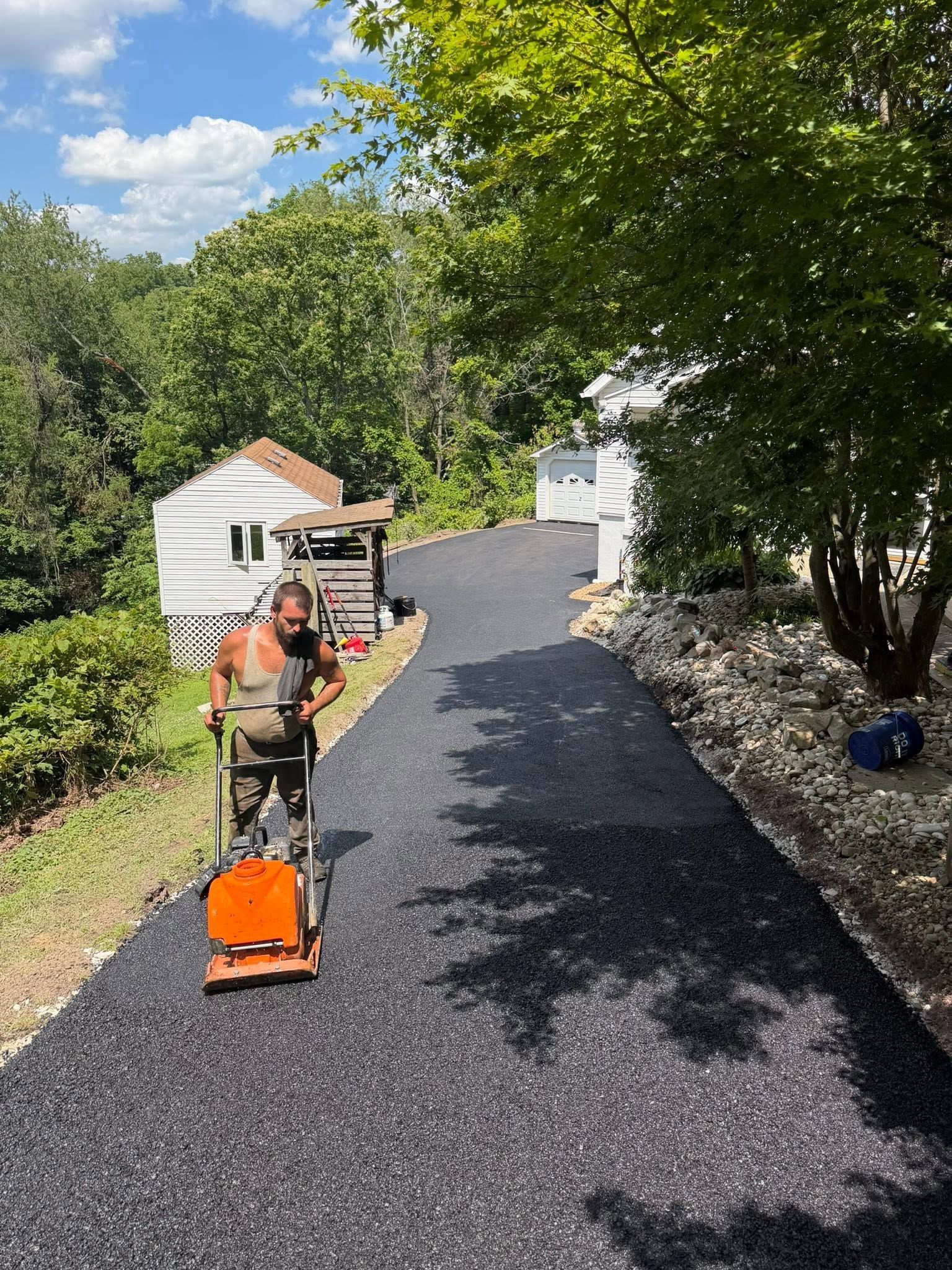 A roller is rolling asphalt on a road.