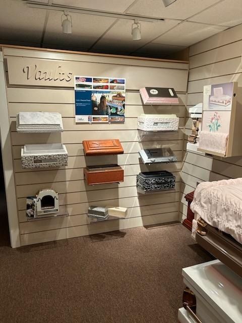 Shelved nursery wall with baby blankets, baskets, and decor in a store display