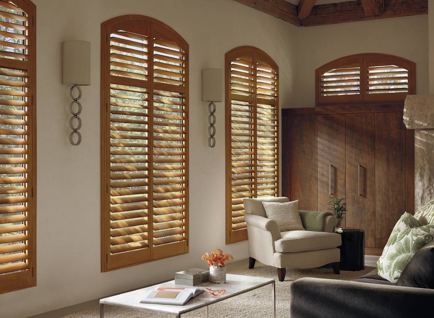 Hunter Douglas Heritance® Wood Shutters covering multiple windows in a living room.