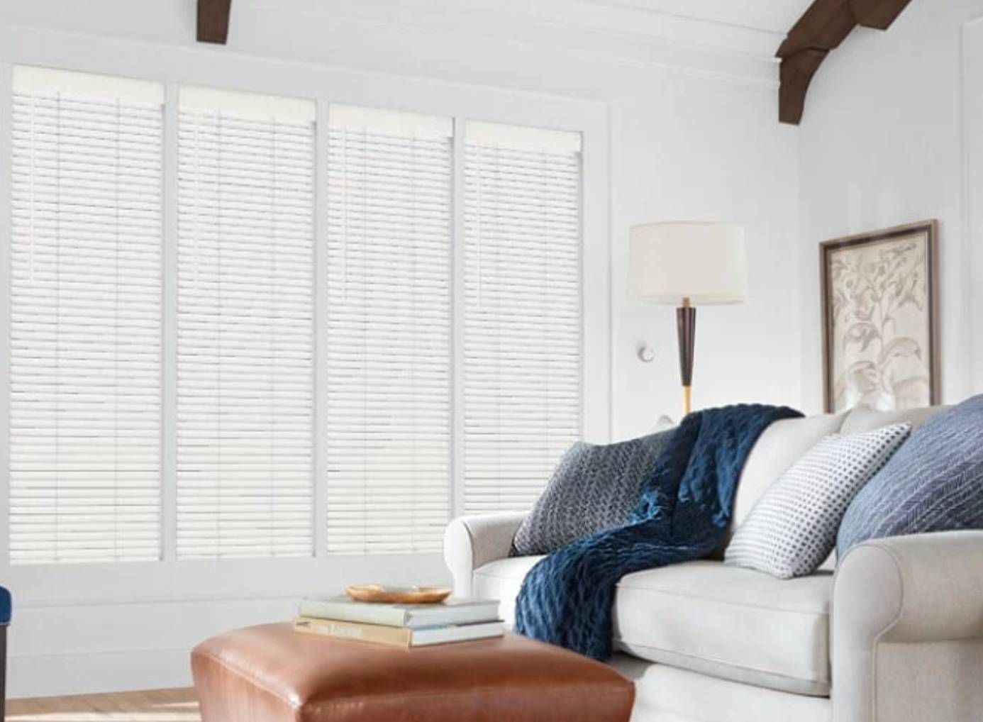 Hunter Douglas Parkland® Wood Blinds covering four large windows in a living room.