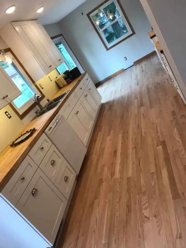 Kitchen with light cabinets, wood countertops, and hardwood floors.