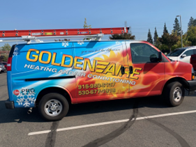 A van for GoldenAire Heating and Air Conditioning parked in a lot, featuring a blue and orange thermal design.