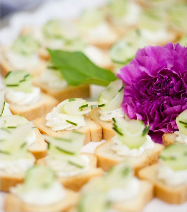 A plate of food with a purple flower in the middle