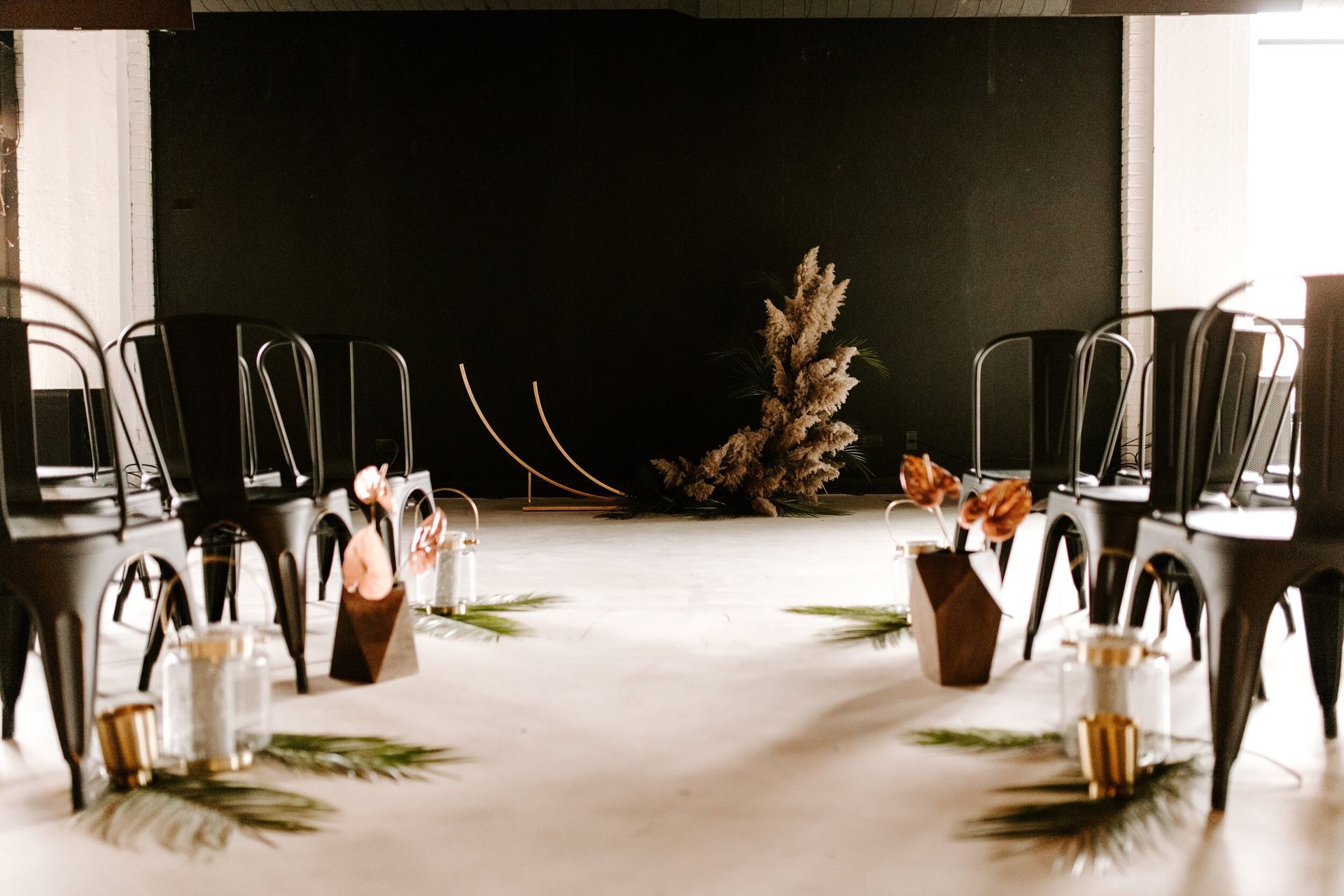 A room filled with chairs and candles for a wedding ceremony.