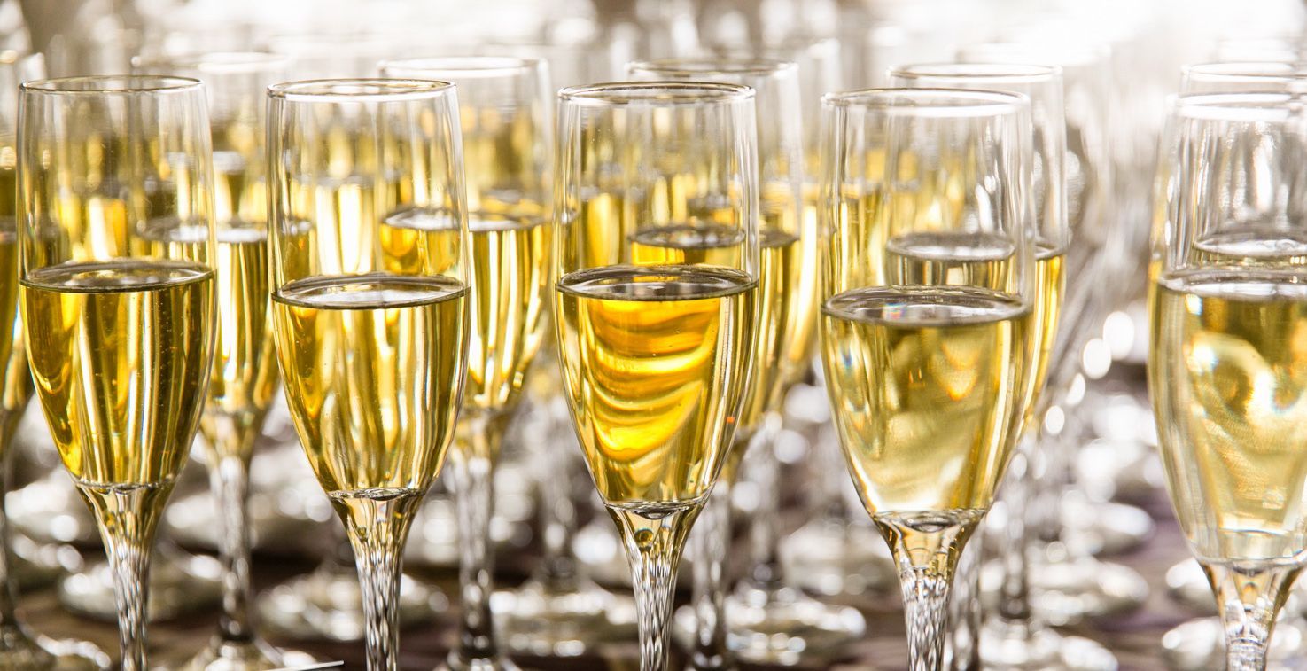 A bunch of champagne glasses filled with champagne on a table.